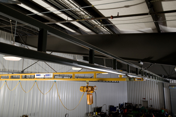 Under-hung ceiling-mounted workstation bridge crane